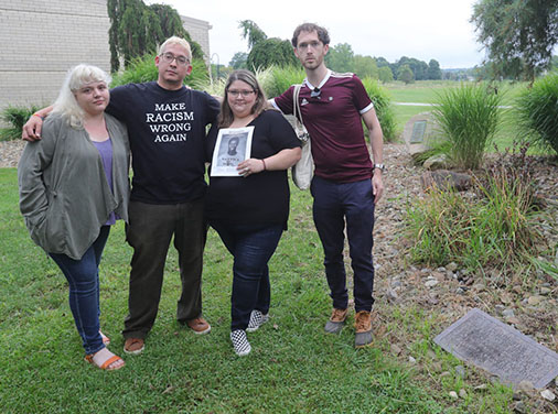 Rachel Jamison, Miguel Carvallo, Melissa Anderson, and Aaron Yeager stop for a photo outside the Stow High School commons area. All are friends of George Garrison Jr. who committed suicide in January of 2003. The group attended the school board meeting afterwards to petition for a memorial garden in Garrison's honor on the school grounds on Monday, August 16, 2021 in Stow, Ohio — courtesy of Phil Masturzo, Akron Beacon Journal.